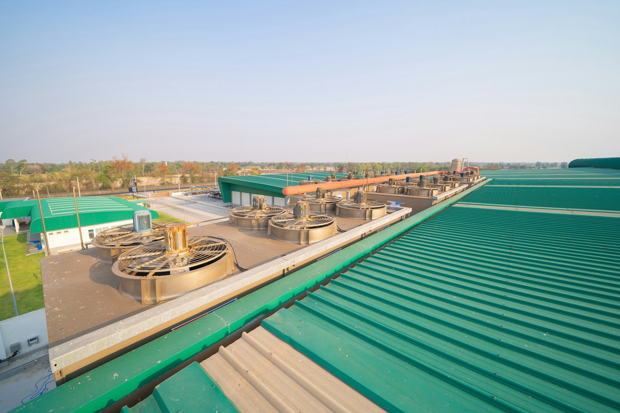 Metal sheet corrugated roof on rooftop of industry factory. Steel structure of station building